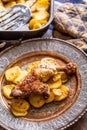 Roasted chicken leg with potatoes with caraway and garlic Royalty Free Stock Photo