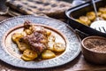 Roasted chicken leg with potatoes with caraway and garlic Royalty Free Stock Photo