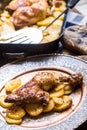 Roasted chicken leg with potatoes with caraway and garlic Royalty Free Stock Photo