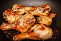 Roasted chicken legs on the black background. Top view