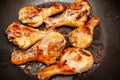 Roasted chicken legs on the black background. Top view