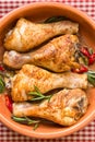 Roasted chicken legs with rosemary, garlic and red chili pepper Royalty Free Stock Photo