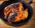 Roasted Chicken legs on a vintage cast iron skillet. Royalty Free Stock Photo