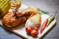 Roasted chicken legs on wooden cutting board Royalty Free Stock Photo