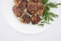 Roasted chicken liver with onion on white background. Top view.