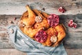 Roasted chicken with pomegranate and garlic on wooden background. Friends or family dinner. Festive Christmas table. Top view. Royalty Free Stock Photo