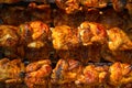 Roasted chicken in a row turning on a roaster