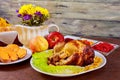Roasted chicken. Thanksgiving table served with , decorated bright autumn leaves and candles. , Royalty Free Stock Photo