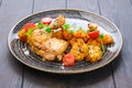 Roasted chicken thigh with fried pumpkin, grilled corn on the cob and tomato Royalty Free Stock Photo