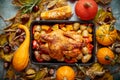 Roasted chicken or turkey garnished with pumpkins, pepper and potatoes. Served on a rustic table