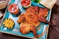 Roasted Chicken or turkey with spices, lemon, tomato sauce, basil and pita bread on plate on dark wooden background. Thanksgiving Royalty Free Stock Photo