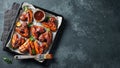 Roasted chicken wings in barbecue sauce with sesame seeds and parsley in a baking tray on a dark table. Top view with copy space. Royalty Free Stock Photo