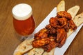 Roasted chicken wings and glass of beer