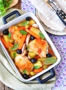 Roasted chiken legs with vegetables and olives