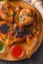 Roasted chiken on wooden board with sauce