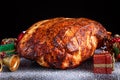 Roasted Christmas ham on board with festive decoration. Royalty Free Stock Photo