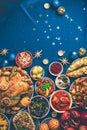 Roasted Christmas turkey with orange slices, cranberries, garlic, festive decoration, candles, tangerine, pomegranate, golden Royalty Free Stock Photo