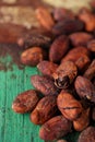 Roasted cocoa chocolate beans on wood background