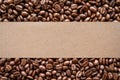 Roasted coffee beans background with blank brown paper label Royalty Free Stock Photo