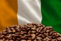 Roasted coffee beans on the background of the flag of the Republic of Ivory Coast. Concept: best flavored coffee, export and impor Royalty Free Stock Photo