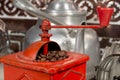 Roasted coffee beans being grinded with a manual coffee grinder Royalty Free Stock Photo