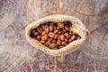 Roasted coffee beans in a brown sack bag. Royalty Free Stock Photo