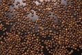 Roasted coffee beans in bulk on a black background