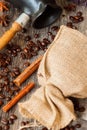 Roasted coffee beans with burlap sac, Cezve, on old weathered wood, cinnamon, anis. Vintage, rustic background . Top Royalty Free Stock Photo