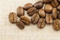 Roasted coffee beans on burlap sackcloth texture background Royalty Free Stock Photo