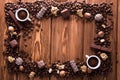 Roasted coffee beans, chocolate, candy, nuts, cup and the frame for inscriptions on wooden background Royalty Free Stock Photo