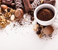 Roasted coffee beans, chocolate, candy, nuts, cup and the place for inscriptions on white background Royalty Free Stock Photo