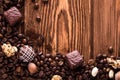 Roasted coffee beans, chocolate, candy, nuts and the place for inscriptions on wooden background Royalty Free Stock Photo