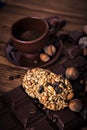 Roasted coffee beans, chocolate, muesli, candy, nuts and cup on the wooden background Royalty Free Stock Photo