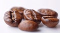 Roasted Coffee Beans Close-up Shot on White Background with Copy Space for Text. Royalty Free Stock Photo