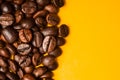 Roasted coffee beans close up. Yellow background. Space for text Royalty Free Stock Photo