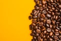 Roasted coffee beans close up. Yellow background. Space for text Royalty Free Stock Photo