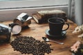 Roasted coffee beans, coffee cup and coffee maker moka pot on wooden desk. Royalty Free Stock Photo