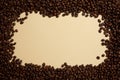 Roasted coffee beans are decorated on a beige background, creating space in the middle for product display or text design. Top Royalty Free Stock Photo