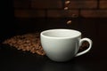 Roasted coffee beans falling into cup. Royalty Free Stock Photo