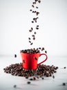 Roasted coffee beans, falling into a red coffee cup, on white background Royalty Free Stock Photo