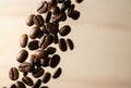 Roasted coffee beans falling on light background Royalty Free Stock Photo