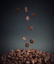 Coffee beans falling into a pile of coffee on the table Royalty Free Stock Photo