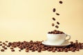 Roasted coffee beans falling into a white cup on a pale background. Generative AI Royalty Free Stock Photo
