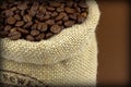 Roasted coffee beans in a flax bag Royalty Free Stock Photo