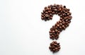 Roasted coffee beans form a question mark on white background. Symbol represents doubt curiosity uncertainty problem search Royalty Free Stock Photo