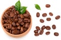 Roasted coffee beans with green leaves in wooden bowl isolated on white background. Top view Royalty Free Stock Photo