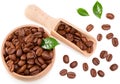 Roasted coffee beans with green leaves and wooden spoon in wooden bowl isolated on white background. Clipping path and full depth Royalty Free Stock Photo