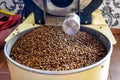 Roasted coffee beans in grinding machine under sunlight