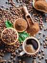 Roasted coffee beans, ground coffee and cup of coffee on wooden Royalty Free Stock Photo