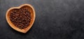 Roasted coffee beans in heart shaped bowl Royalty Free Stock Photo